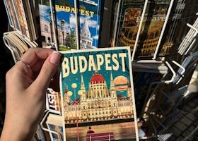 Top 10 Hidden Gems in Budapest Only Locals Know A collection of vibrant Budapest postcards displayed outdoors under sunlight.