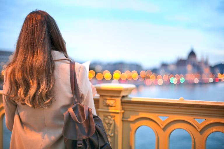 A woman enjoys a scenic view of Budapest